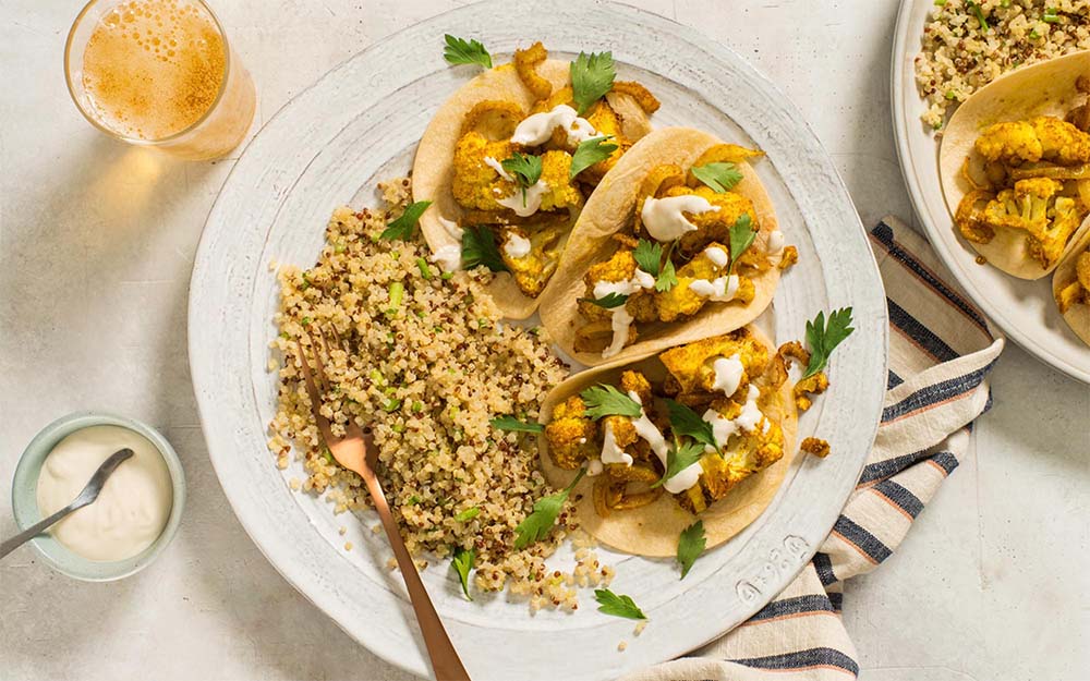 Cauliflower Shawarma Tacos with creamy tahini sauce and a lemony quinoa salad,